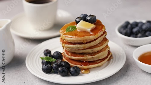 Pancakes with berries, butter and maple syrup