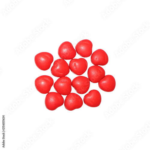 Pile of red heart-shaped candies with textured surface in studio lighting