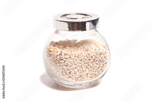 pearl barley in a jar isolated on white.