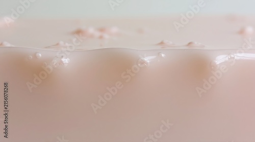 Pale blush wax with small trapped air bubbles, a smooth glossy surface and subtle irregularities, creating a tactile imperfect background for branding and modern design.