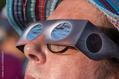 Person watching solar eclipse with protective eyewear
