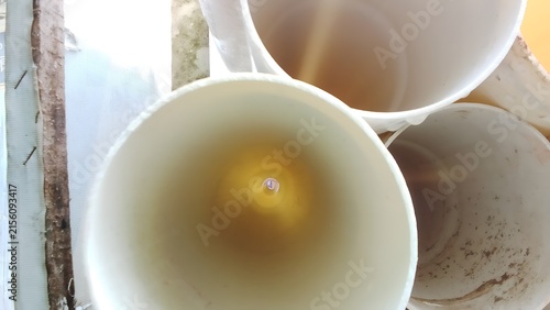 Top down view inside white plastic buckets with container industrial cylinder interior material