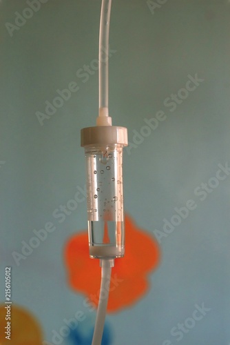 IV drip chamber with medical solution, close up of intravenous infusion equipment in hospital