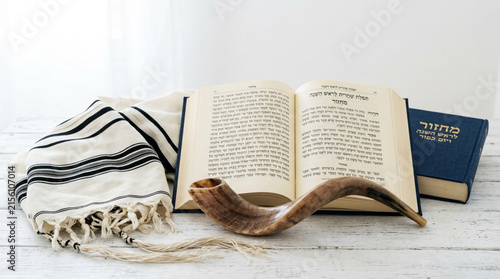 Jewish prayer shawl tallit with shofar horn and open hebrew holy book