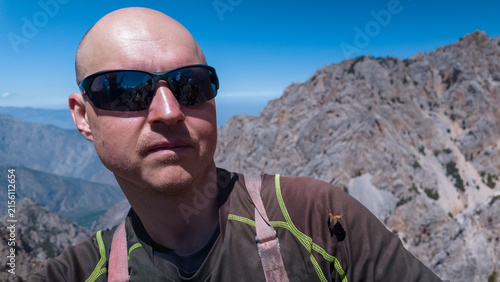 Canvas Print A man stands proudly at a mountain overlook, basking in the beauty of the Pamir mountains in Kyrgyzstan