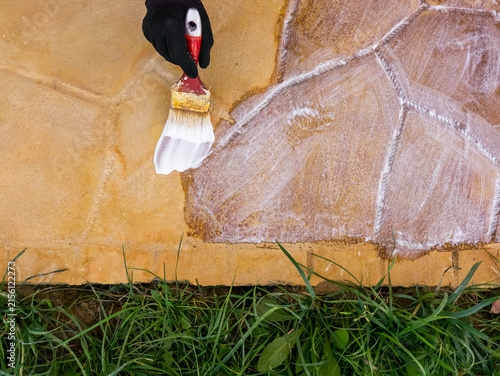 Фотография acrylic lacquer coating of yellow concrete tiles close-up