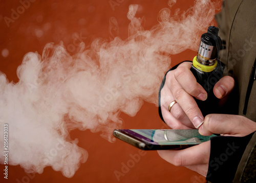 Cuadro en lienzo a man smokes an electronic cigarette. VAPE lets smoke