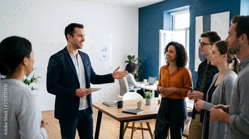 Confident young businessman presenting new strategy to smiling team in office
