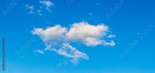 Single white cloud of unusual shape on vivid deep blue sky