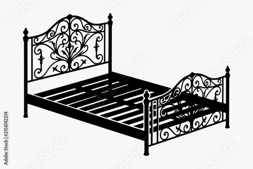 Фотография Ornate wrought iron bed frame with a decorative headboard and footboard, highlig