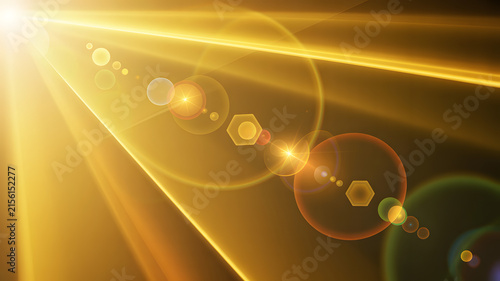 Bright golden sun flare glowing across dark background backdrop
