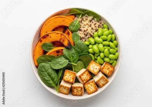 Vibrant vegetarian bowl featuring roasted pumpkin, fluffy quinoa, fresh baby spinach, green edamame beans, and cubes of seared organic tofu, colorful, healthy, spinach