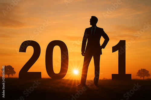 Silhouette Of Businessman Standing Before Numerals Two Zero Two One At Dusk