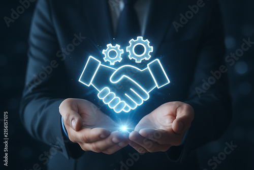 Glowing handshake with gears held in cupped hands illuminated outline
