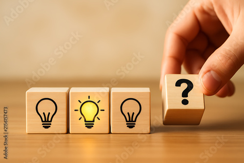 Wooden blocks with lightbulb icons and question mark conceptual photography