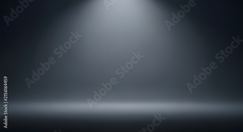 Spotlight illuminates an empty dark studio background creating a clean stage for product placement.