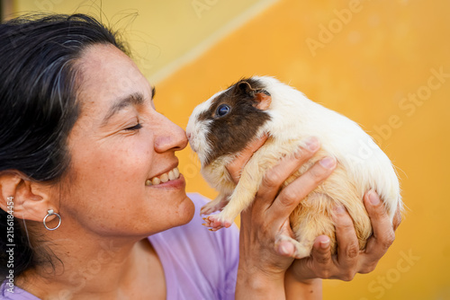 Woman bonding with pet guinea pig
