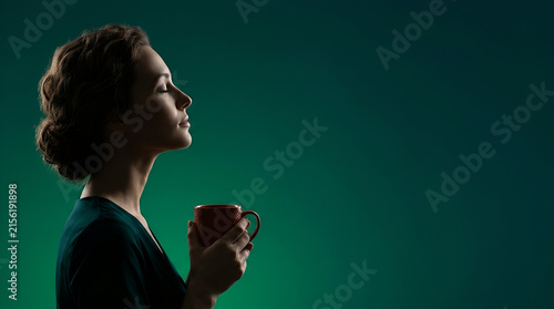 woman enjoying aroma of hot tea with closed eyes