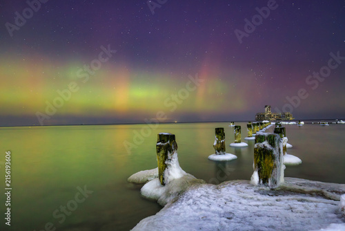 Baltic sea in Gdynia Babie Doly at winter night with northerm lights. Poland