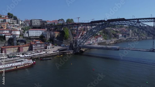 Porto, Portugal cityscape with the Douro River and historic bridges, featuring the Infante Bridge and Maria Pia Bridge, surrounded by traditional Portuguese architecture and scenic urban landscape.