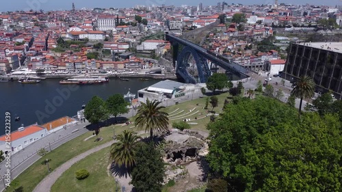 Porto, Portugal cityscape with the Douro River and historic bridges, featuring the Infante Bridge and Maria Pia Bridge, surrounded by traditional Portuguese architecture and scenic urban landscape.
