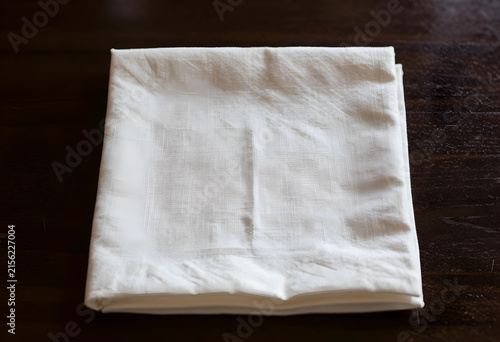 Folded white linen napkin o...