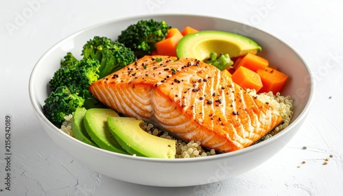 Healthy salmon grain bowl with avocado and fresh broccoli.
