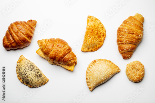 Still life with a variety of breakfast items, empanadas, croissants and much more
