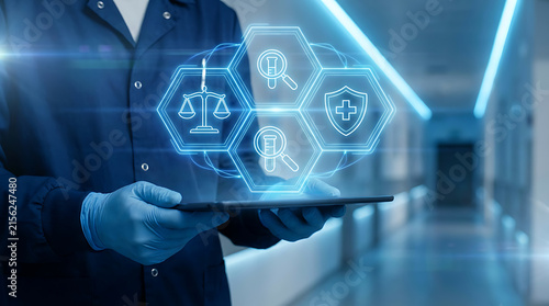 Medical professional holding a digital tablet with holographic icons of lab testing, legal balance, and health protection, representing healthcare compliance and savings.