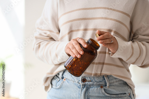 Person holding a brown glas...