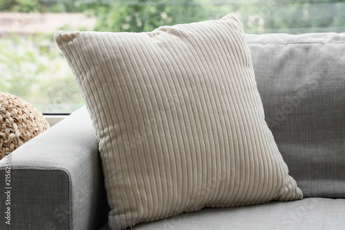 Quadro su tela Beige corduroy throw pillow on a gray sofa, home decor and comfortable living ro