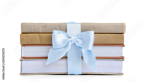 Cuadro en lienzo Stack of books tied with blue ribbon on white background