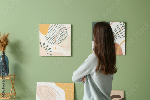 Young woman looking at pain...