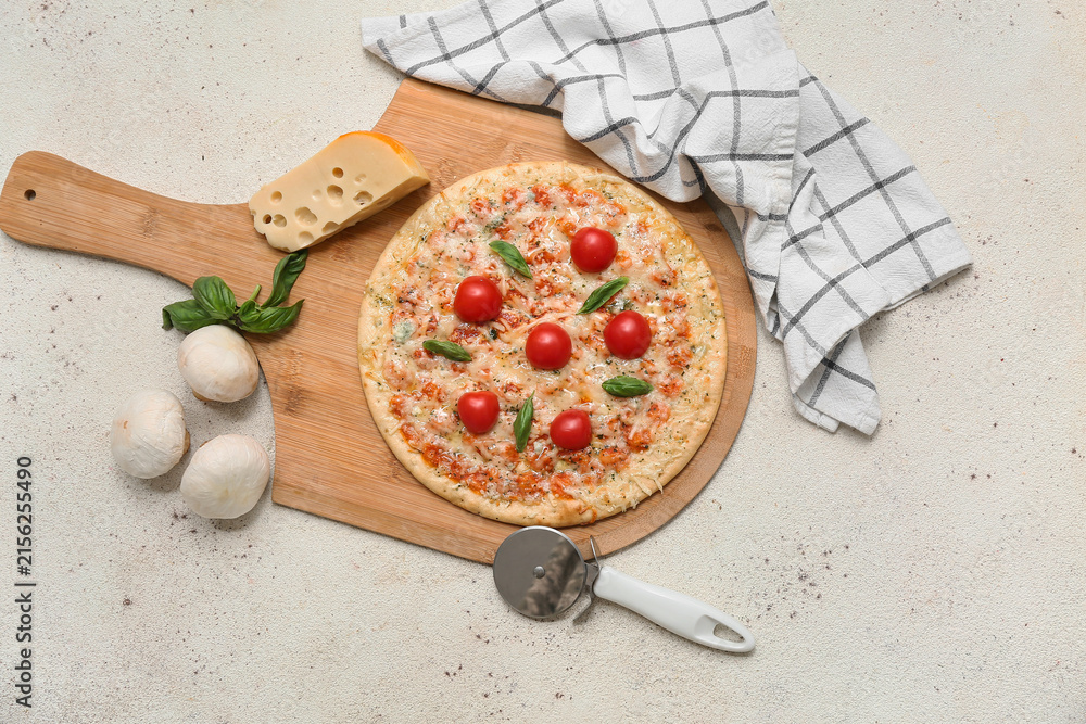 Fototapeta premium Tasty pizza, cutter and ingredients on light background