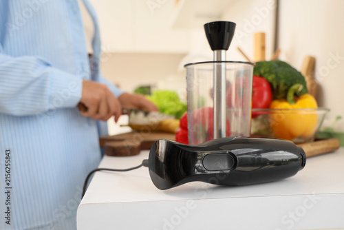 Hand blender on table of wo...