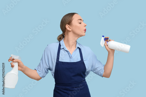 Young woman with spray bott...