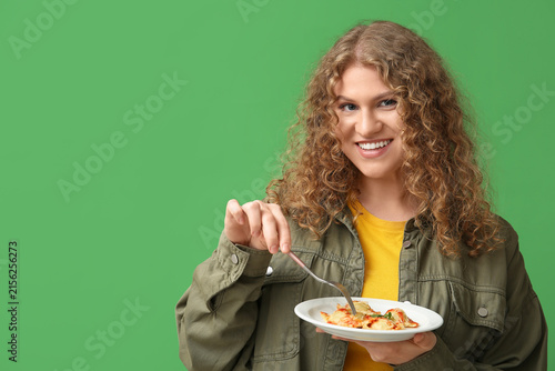 Happy young woman with fork...