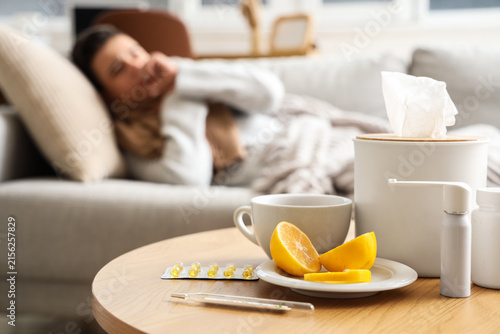 Medications with lemon on table of sick little boy at home, closeup
