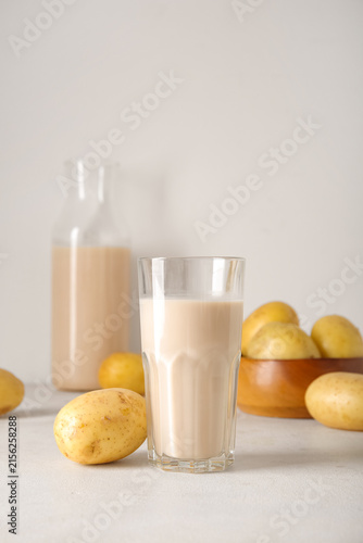 Glass of tasty potato milk ...