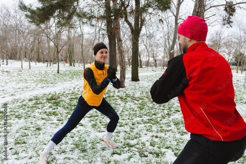 Fototapeta premium Two active friends fighting snow during an active winter day