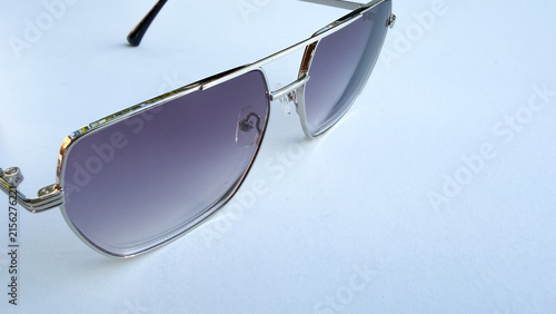 Obraz na płótnie Modern aviator sunglasses with tinted lenses on clean white background, fashionable eyewear, summer accessory