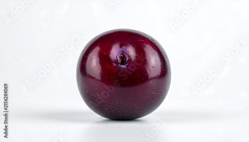 Close up view of a single glossy red cherry.