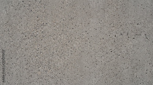 Exposed concrete texture background. Gray cement wall surface with natural stone aggregate.
