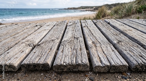 Sun-bleached driftwood boards on beach. Weathered wooden planks by the ocean shore.