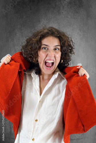 Beautiful young woman in an emotional pose against a neutral background.