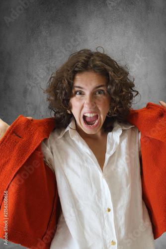 Beautiful young woman in an emotional pose against a neutral background.