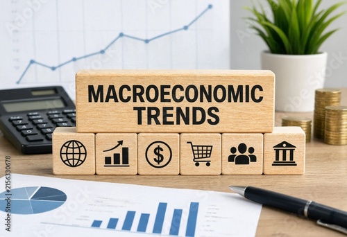 Macroeconomic trends illustrated with financial icons and charts on a wooden desk workspace