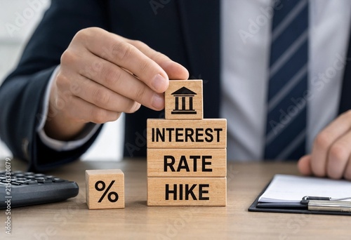 Professional placing wooden blocks to illustrate an interest rate hike by central bank during business meeting