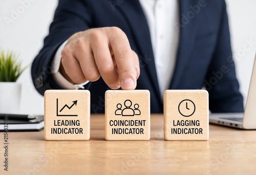 Business professional selecting indicators representing leading coincident and lagging economic metrics on wooden blocks