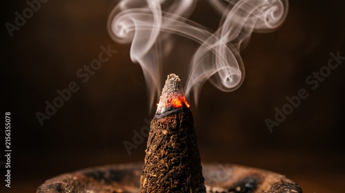 Burning Incense Cone Emitting White Smoke with Glowing Ember. Spiritual Meditation Ritual Design and Religion and Culture